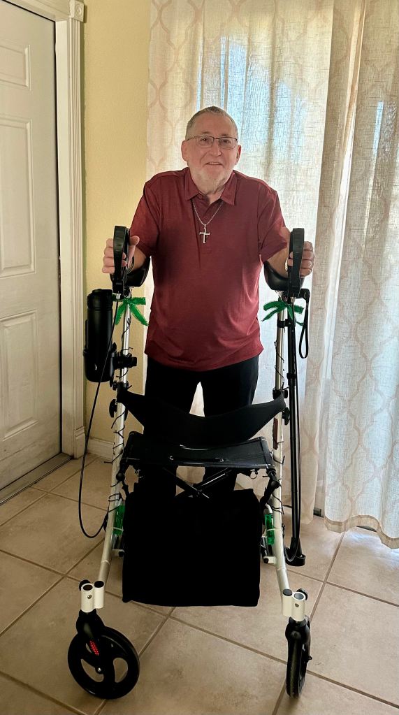 John standing with a walker 